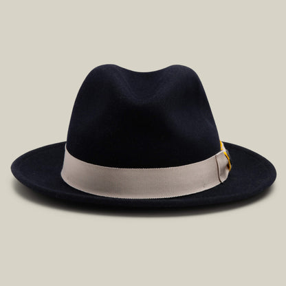 Dean the Butcher by Goorin Bros. is a dark EDGE felt fedora, made in the USA, featuring a wide brim and a light grosgrain hatband, displayed against a simple, light background.