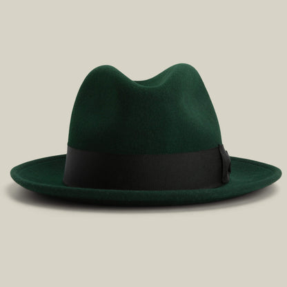Dean the Butcher by Goorin Bros. in GUARD, a dark green felt American-made fedora with a black grosgrain hatband, shown on a light beige background.
