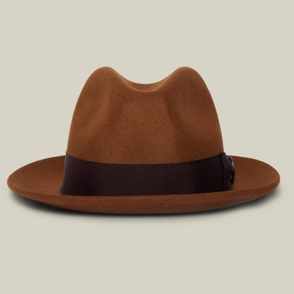 Dean the Butcher by Goorin Bros. is a whiskey-colored American-made fedora with a wide, dark brown grosgrain hatband, shown on a neutral background.