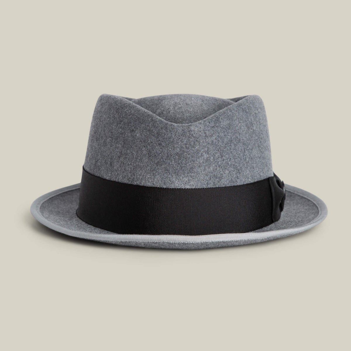 The Goorin Bros. Slick Carter is a gray wool short brim fedora with a black ribbon band, shown against a plain beige background.