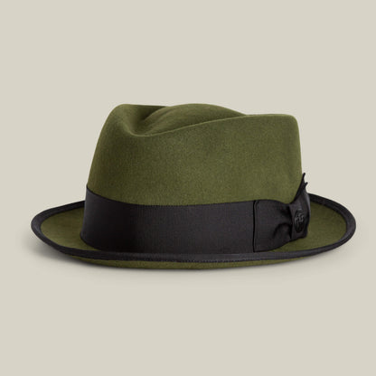 The Slick Carter by Goorin Bros. is an olive green wool fedora with a short brim, finished with a black ribbon band and bow, shown against a plain light background.