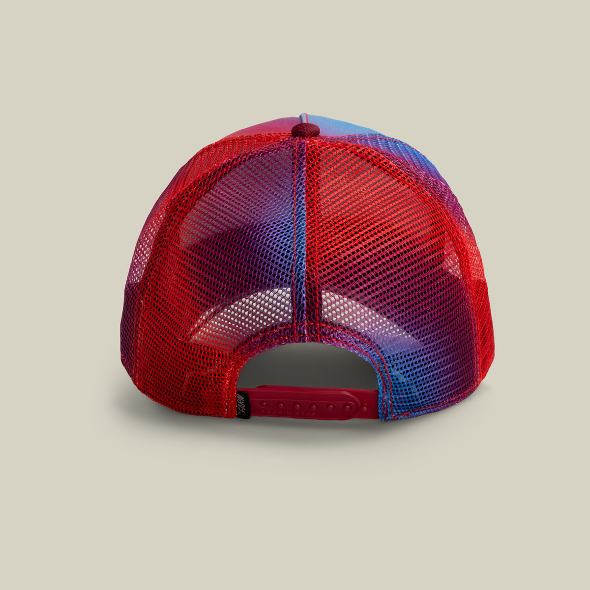 A back view of the Bird is the Word red and blue mesh trucker hat by The Farm, featuring an adjustable snapback closure. All sales are final.
