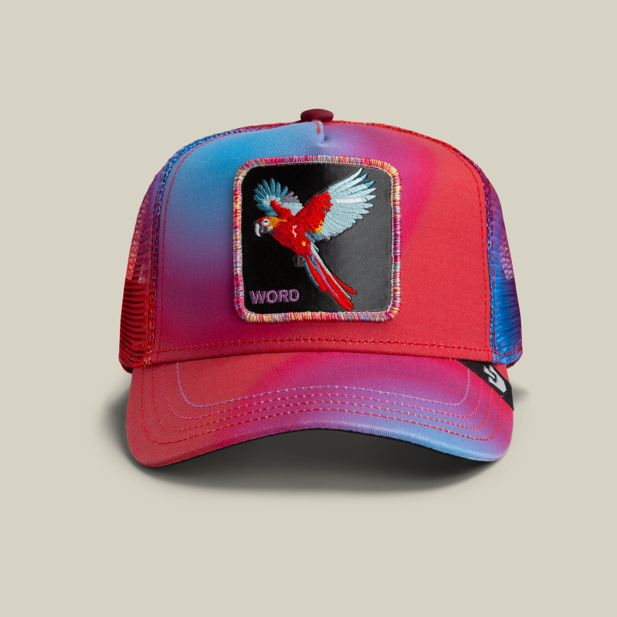 The Farm’s Bird is the Word cap is a red mesh trucker hat with an embroidered parrot patch and “WORD” on the front panel. All sales final.