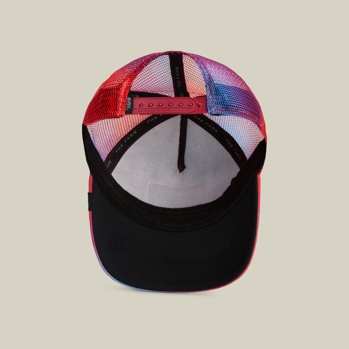 The Farm's "Bird is the Word" red and black mesh trucker cap shown inside-out, highlighting its adjustable snapback strap and interior lining against a plain light background. All Sales Are Final.
