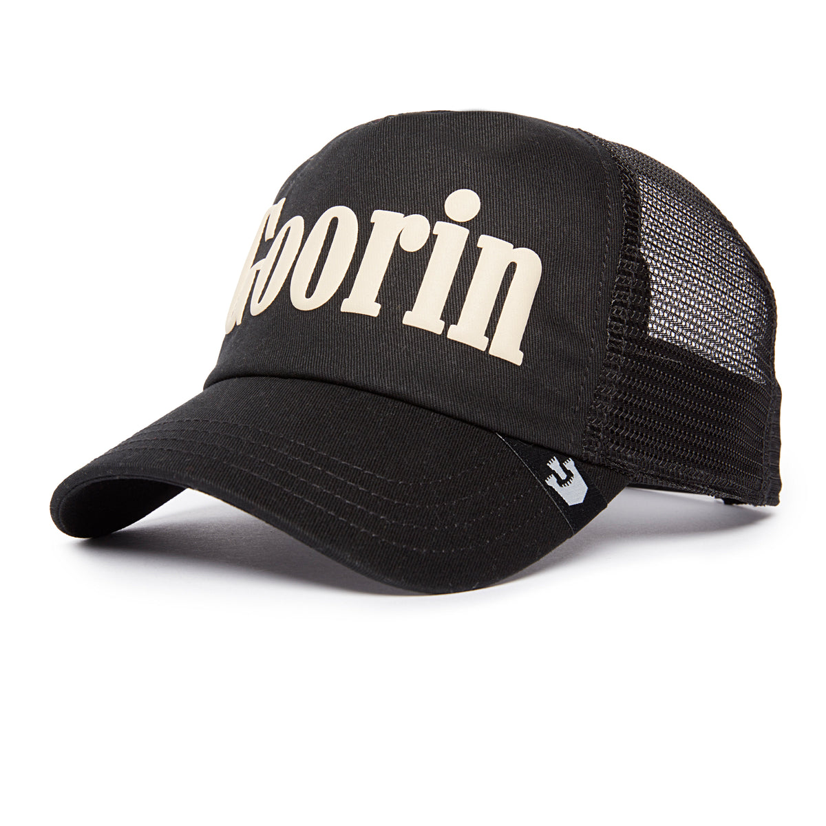 Soft Pack is a black mesh trucker hat from Goorin Bros., featuring bold white “Goorin” text on the front. It has a curved brim and a ventilated mesh back, making it a subtly standout addition to any casual wardrobe. Please note: All Sales Are Final.
