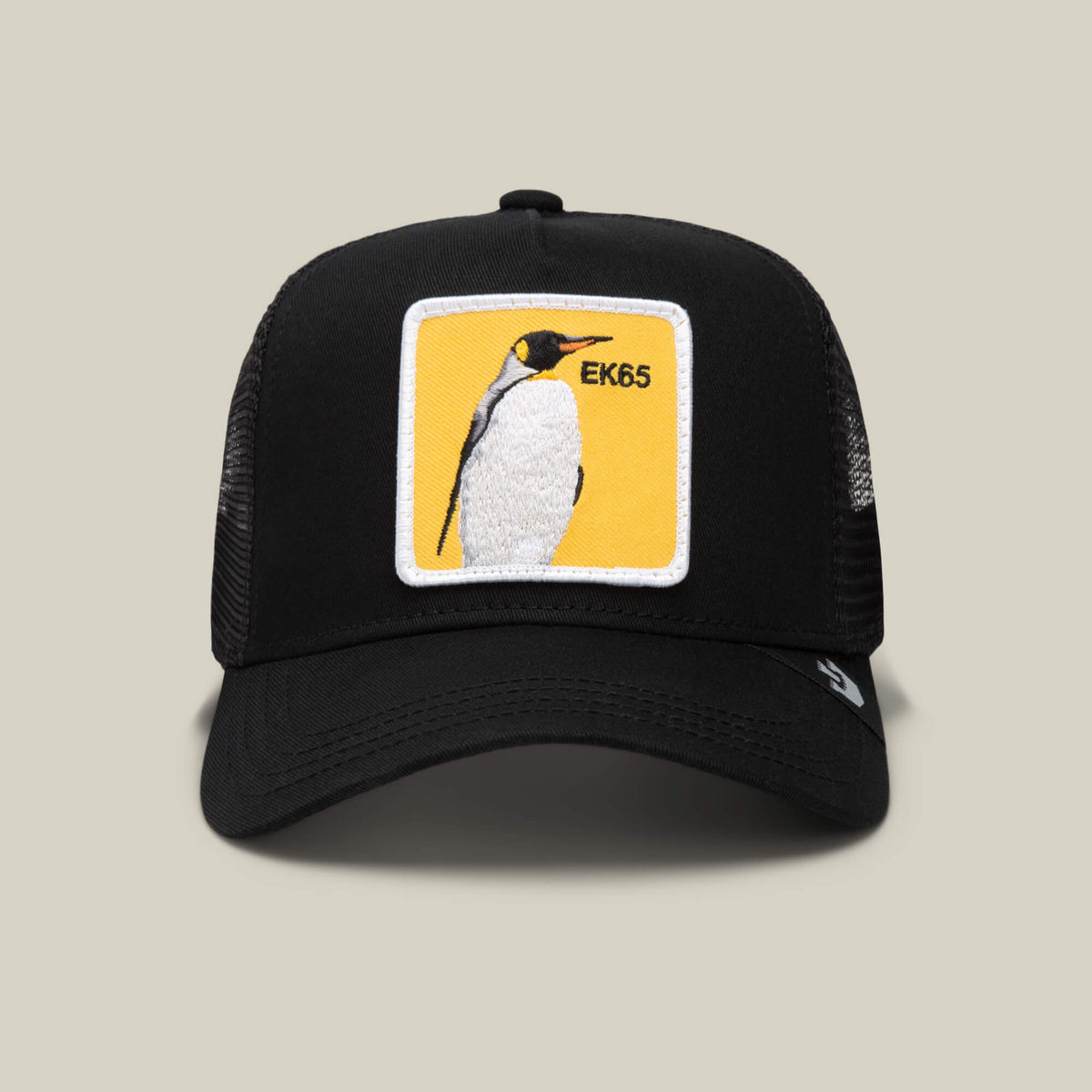 The Goorin Bros. EK65 Penguin cap features black mesh, a yellow patch with an embroidered emperor penguin and EK65 on the front—a limited drop ideal for penguin fans and collectors.