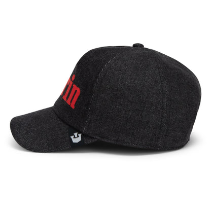 The Smoke Signal baseball cap by Goorin Bros. features dark gray stonewashed denim with red lettering partially visible on the front, viewed from the left side. A small black and white Goorin label is attached near the brim.