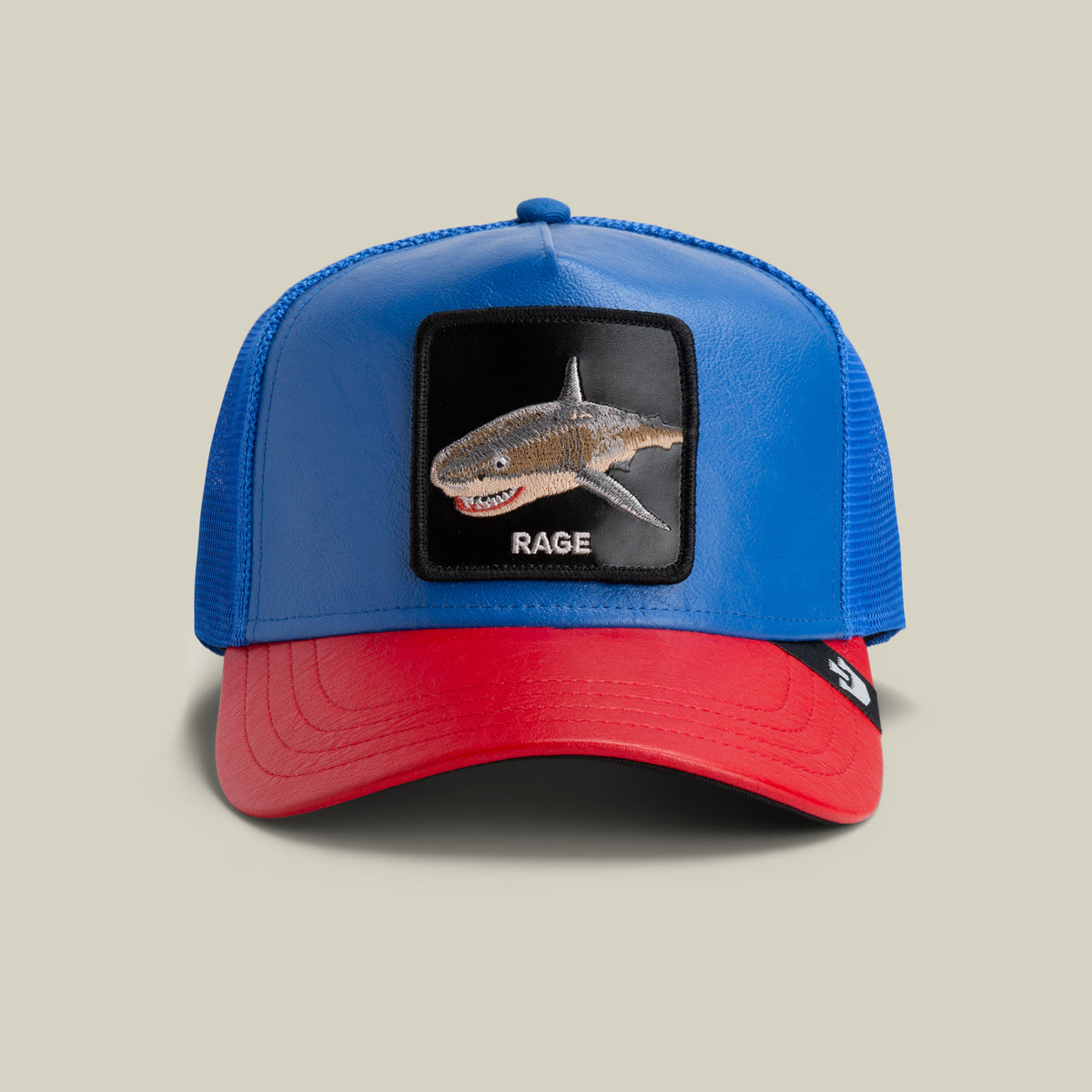 The Farm’s Deep Blue Fury is a blue trucker hat with a shark patch and "RAGE" embroidery on the front; all sales are final.