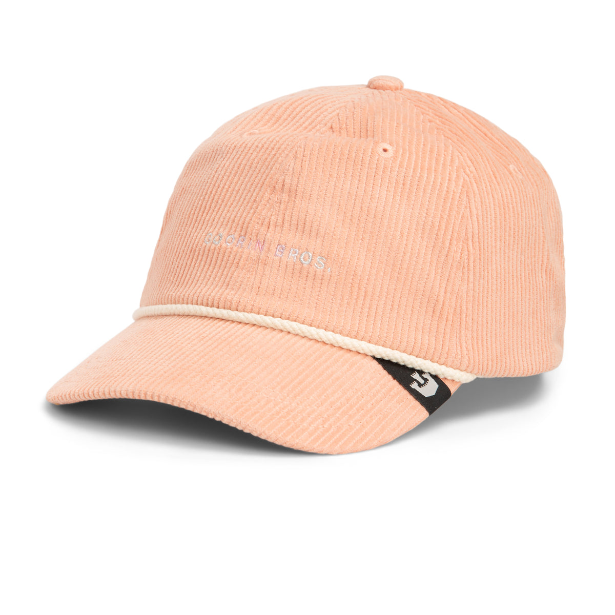 A light pink wide wale corduroy baseball cap from Goorin Bros., The Clubhouse features a white rope detail above the brim and a small black tag with a white logo on the left side, exuding quiet luxury in every detail.
