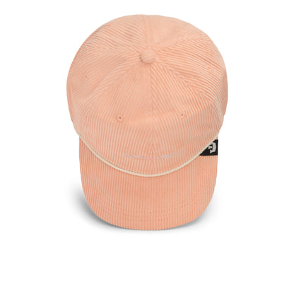 The Clubhouse by Goorin Bros. is a peach-colored Papa Cap made from wide wale corduroy, featuring a curved brim and a small logo tag on the side, epitomizing quiet luxury and showcased against a white background.