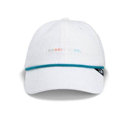 The Clubhouse by Goorin Bros. is a white Papa Cap baseball cap featuring a turquoise stripe above the brim, pastel GOORIN BROS. text on the front, and a small black tag on the left side—crafted from wide wale corduroy for an elevated take on quiet luxury.