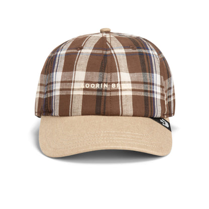 The “Ask Your Mother” cap by Goorin Bros. features a brown and beige plaid pattern with the GOORIN BROS. text on the front, a beige brim, and a small black tag on the left side of the brim. This relaxed hat effortlessly blends classic style with comfort, making it an ideal addition to any casual outfit.