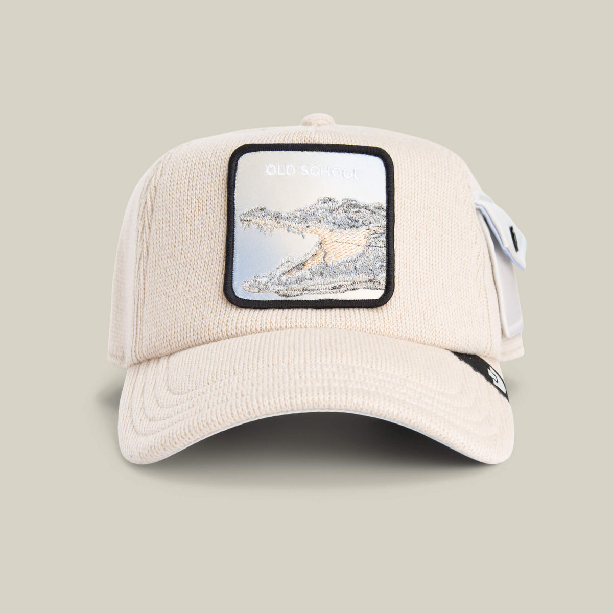 The Goorin Bros. AllmiMator TOAST cap features a patch with an embroidered crocodile and "OLD SCHOOL" text on the front, channeling vintage sweater style.