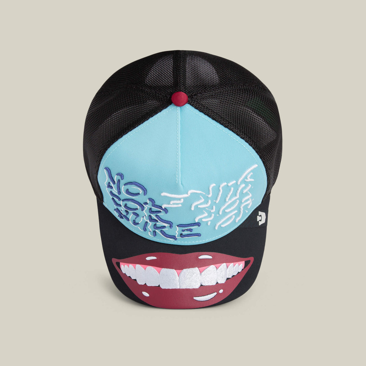 The "Means Understood" hat by Goorin Bros. is a black and light blue mesh cap with embroidered text, a brain graphic on the front, and a large illustration of smiling lips on the brim.