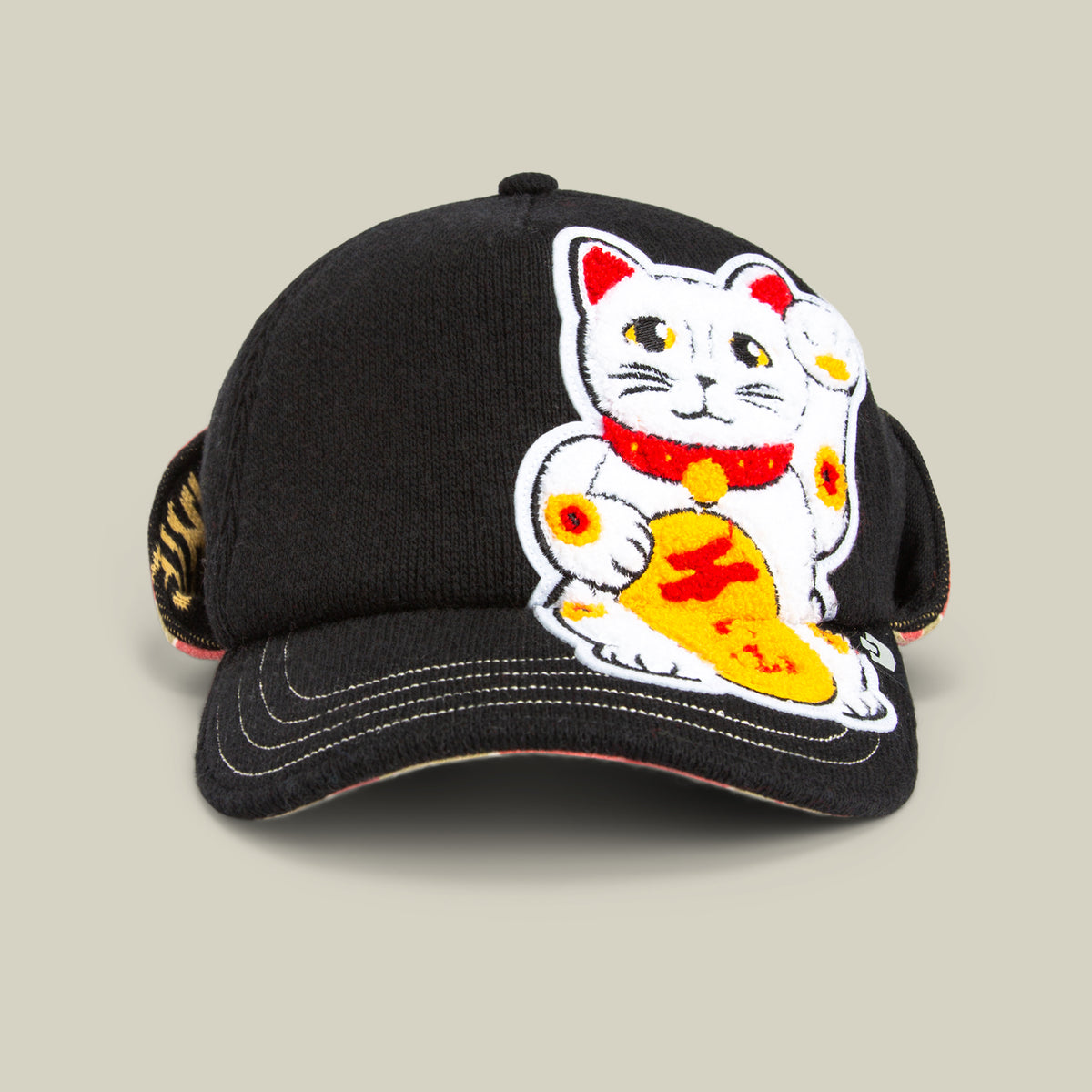 The F is for Fortune cap by Goorin Bros. in VOID features an embroidered white lucky-cat (maneki-neko) with yellow and red accents on the front, adding winter charm to your style.