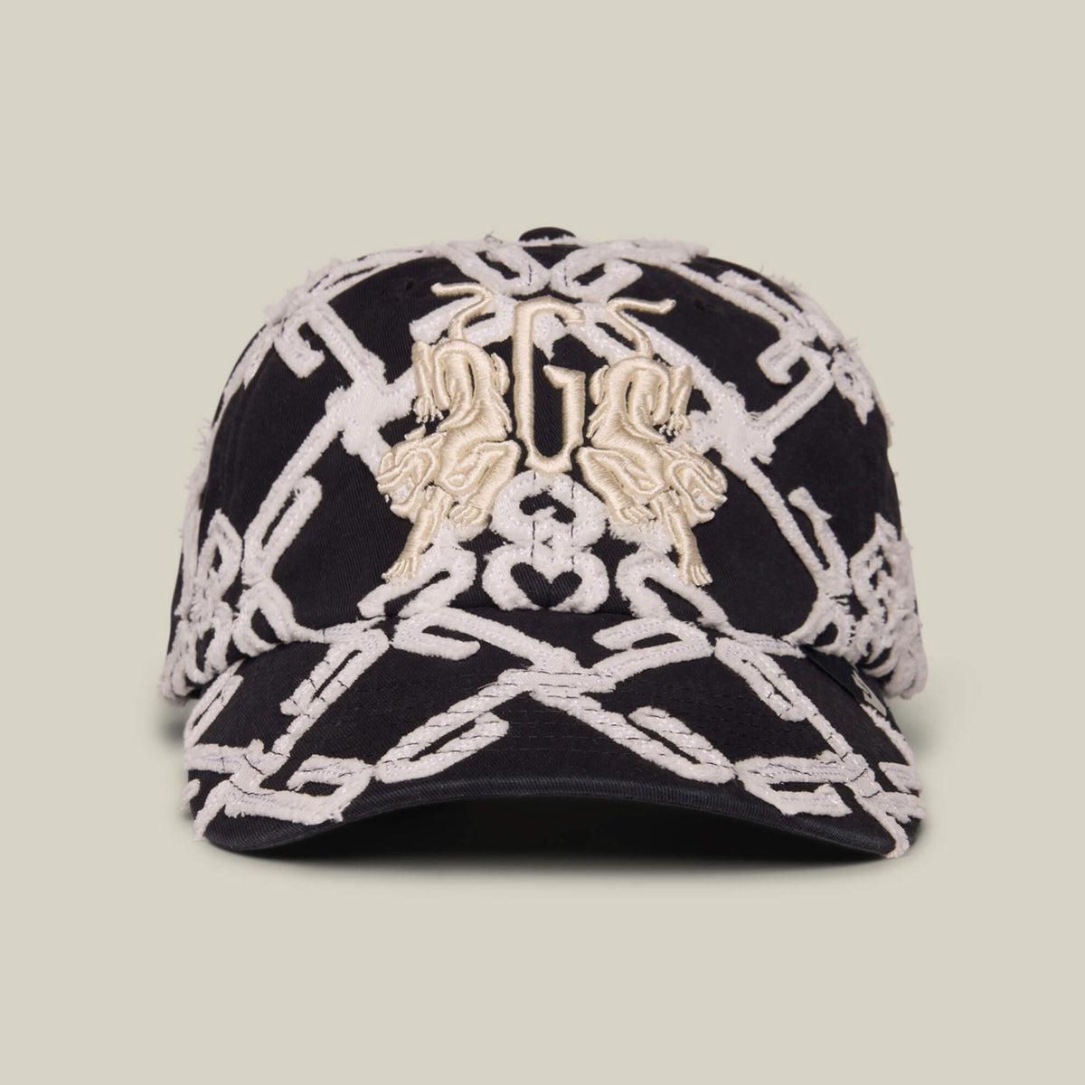 Front view of the Goorin Bros. Future Baby Daddy cap in DUST / VOID, showcasing full embroidery with a bold white chain pattern and two gold animal accents on the front for standout style.