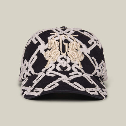 Front view of the Goorin Bros. Future Baby Daddy cap in DUST / VOID, showcasing full embroidery with a bold white chain pattern and two gold animal accents on the front for standout style.