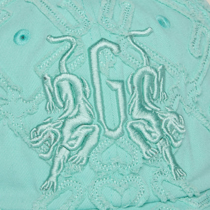 The Goorin Bros. Future Baby Daddy cap features aqua fabric with all-over embroidery, two mirrored lions, and central GU letters—perfect for main character vibes.