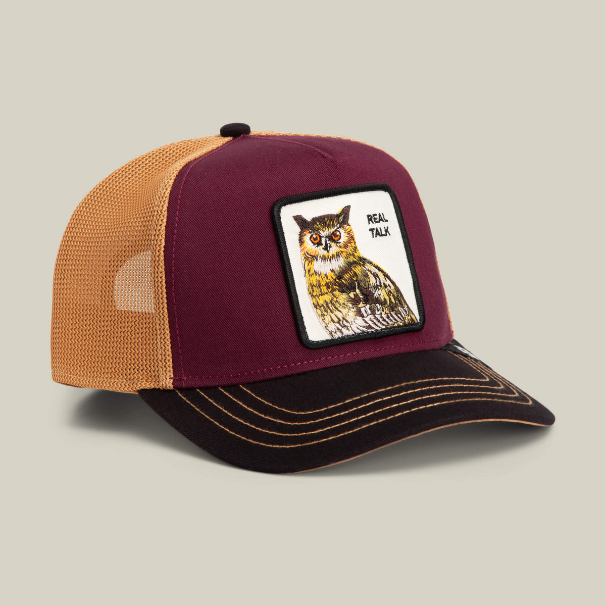 The Goorin Bros. Tricolor Owl cap features a maroon, tan, and black design with an owl patch and "REAL TALK" text on the front—an eye-catching addition to any hat collection.