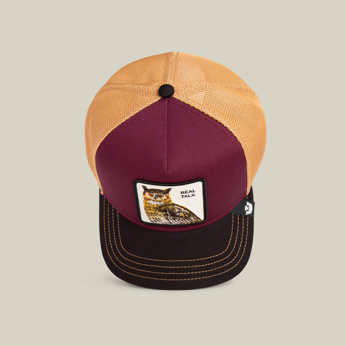 The Tricolor Owl cap by Goorin Bros. features a deep maroon crown, honey mesh back, and a front patch with an owl and "REAL TALK.