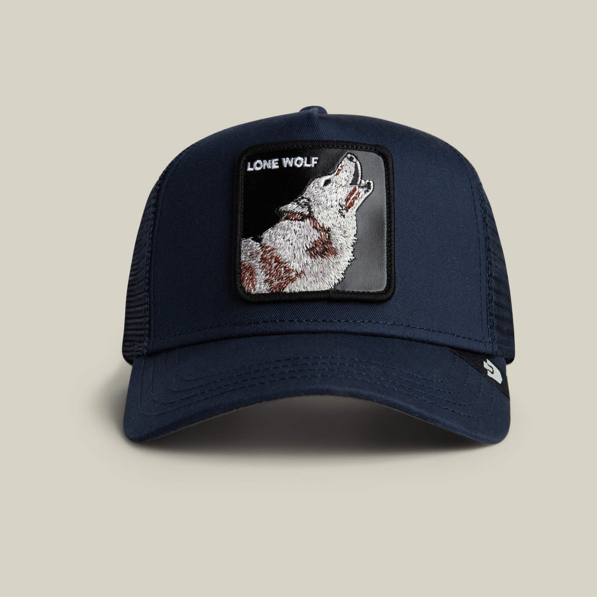 The Lone Wolf Trucker by Goorin Bros. in EDGE features a patch with a howling wolf and "LONE WOLF" text—an ideal pick for anyone with an outlaw spirit.