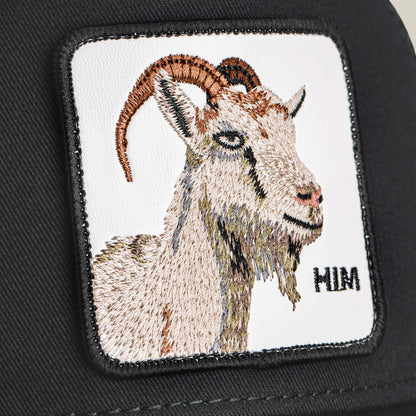 Embroidered patch featuring a GOAT's head with curved horns on black fabric, detailed stitching, and "MIM" text in the lower right. Product: Him Trucker by Goorin Bros.