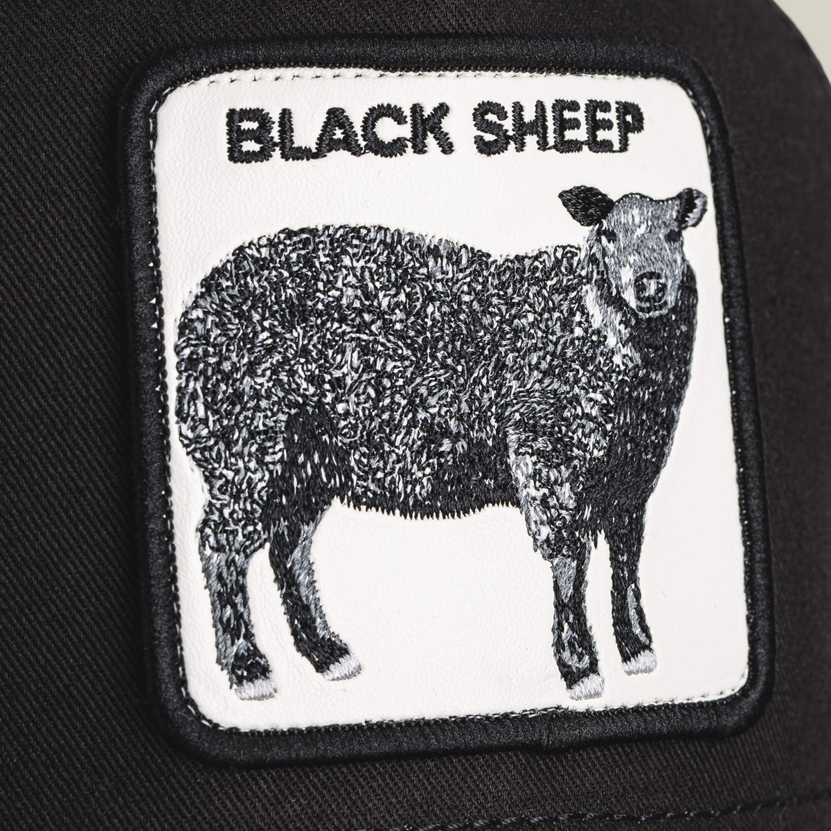 The Black Sheep Trucker by Goorin Bros. features a rectangular patch with a black sheep and bold "BLACK SHEEP" text—ideal for anyone who stands out and embraces individuality.