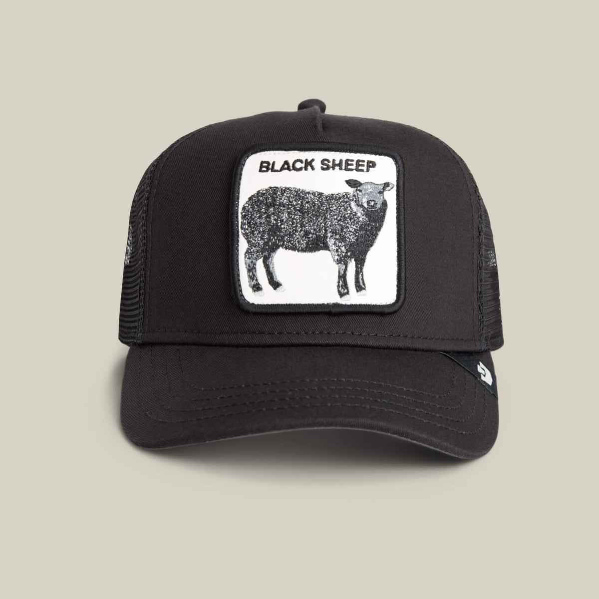 The Goorin Bros. Black Sheep Trucker in VOID features a front patch with a black sheep and "BLACK SHEEP" text—ideal for anyone bold enough to stand out.