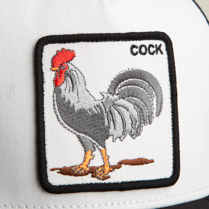 A white Rooster Trucker hat by Goorin Bros., featuring a stitched rooster patch and the word "COCK" in the top right corner.