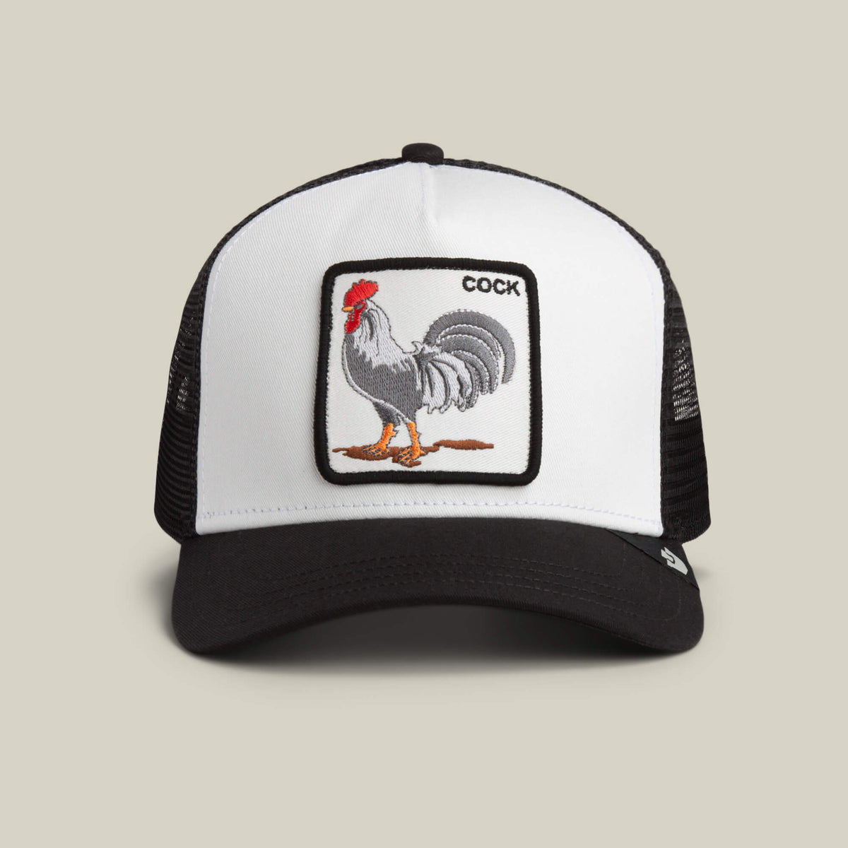 A DUST / VOID Rooster Trucker hat by Goorin Bros., featuring a rooster patch with the word "COCK" in the top right corner of the patch.