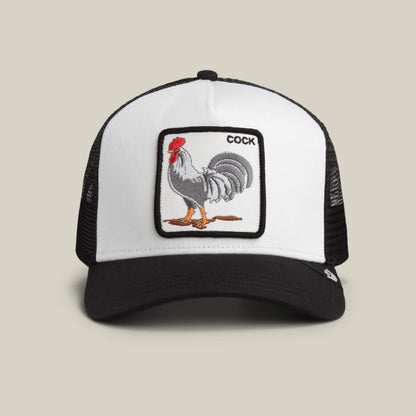 A DUST / VOID Rooster Trucker hat by Goorin Bros., featuring a rooster patch with the word "COCK" in the top right corner of the patch.