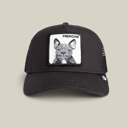 The Frenchie Trucker by Goorin Bros. is a bold black trucker cap in VOID color, featuring mesh sides and a front patch with an illustrated gray French Bulldog and the word "FRENCHIE" above it—an ideal hat for every Frenchie fan.