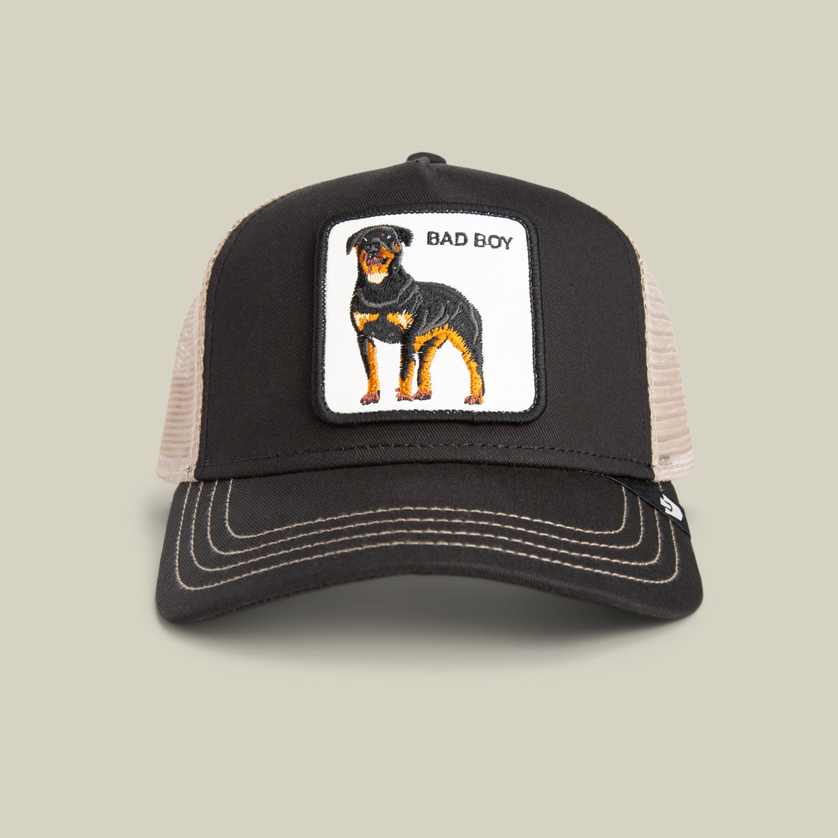 The Goorin Bros. Bad Boy Trucker in VOID features a Rottweiler patch and BAD BOY text—a bold accessory for edgy style lovers.