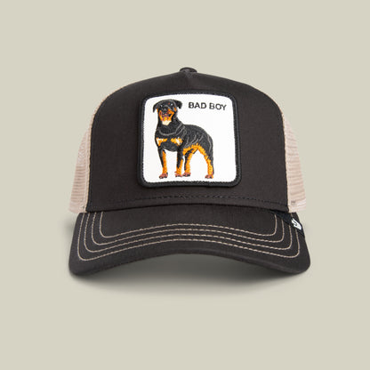 The Goorin Bros. Bad Boy Trucker in VOID features a Rottweiler patch and BAD BOY text—a bold accessory for edgy style lovers.