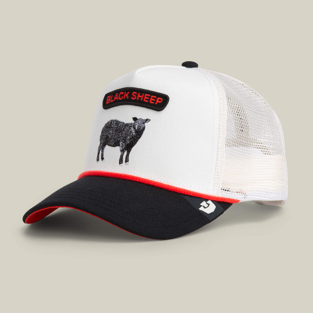 The Goorin Bros. Pop Rocker Sheep is a white and black trucker cap with a mesh back, black brim, red accents, and an embroidered patch of a black sheep with "BLACK SHEEP" text on the front.