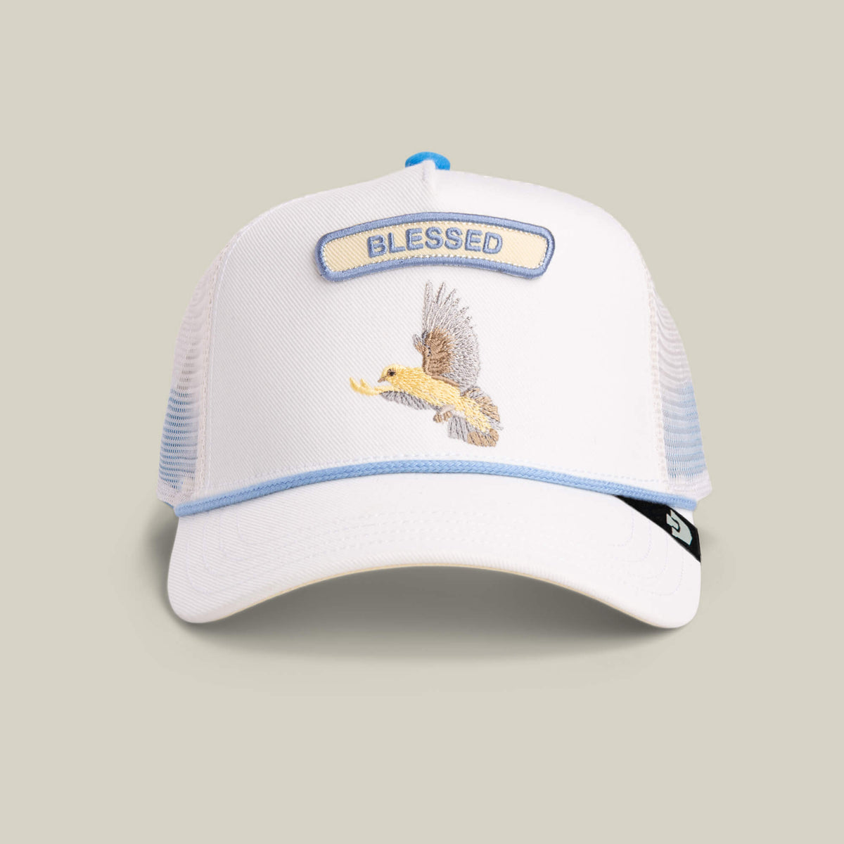The Goorin Bros. Pop Rocker Blessed hat features a blank mesh back, a blue-bordered BLESSED patch, an embroidered eagle on the front, and a small logo tag on the brim for subtle branding.