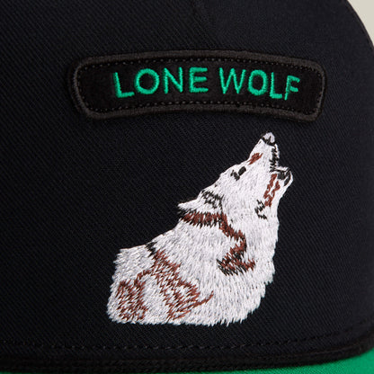 Close-up of the Goorin Bros. Pop Rocker Wolf hat, featuring bold wolf embroidery and a green-lettered "Pop Rocker Wolf" patch on a stylish black mesh back cap.