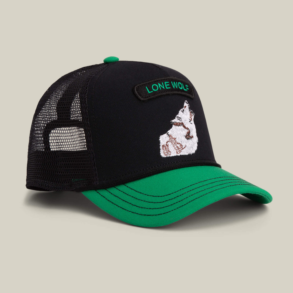 Black and green mesh back cap by Goorin Bros., named Pop Rocker Wolf, featuring bold “LONE WOLF” text and detailed wolf embroidery on the front panel.