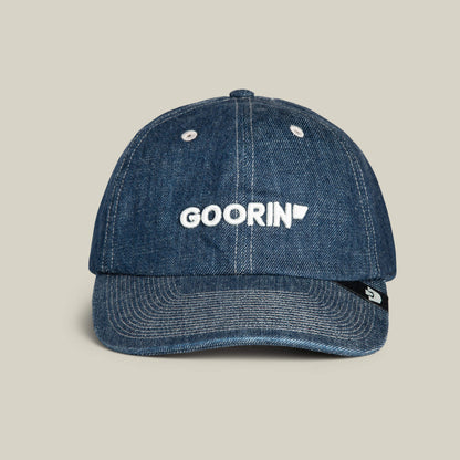 The Papa Core Denim cap by Goorin Bros. comes in PENNANT blue denim with white stitching, featuring the GOORIN wordmark embroidered on the front and a small black tag on the left side.