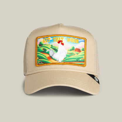 The Goorin Bros. Greener Grass - Get that Worm hat in TOAST features a mesh back and a colorful farm scene patch with a chicken, farmland background, and “GET THAT WORM” text.