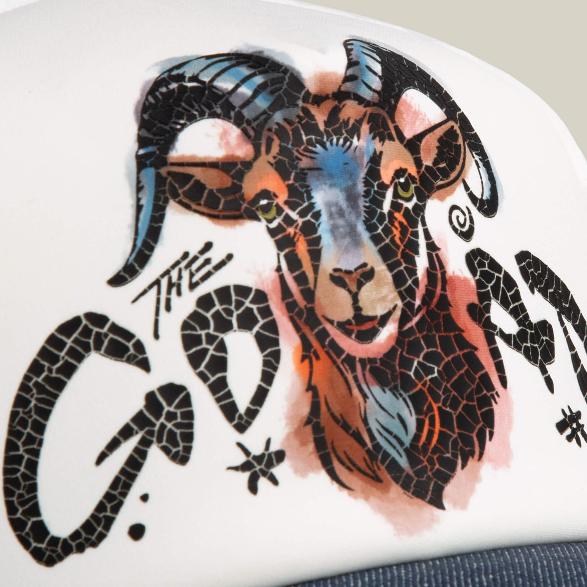 Add bold flair to any trucker hat with Goorin Bros.’ Goat Disruption patch, featuring a hand-illustrated goat’s head with large curved horns and stylized cracked-texture “THE GOAT” text.