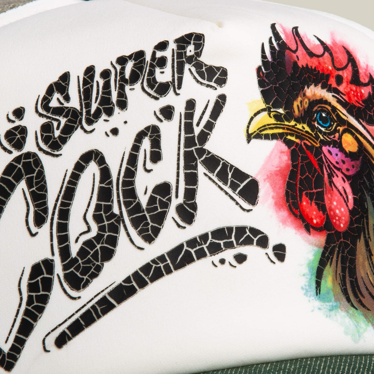 A close-up of a vibrant, hand-illustrated rooster's head and the words COCK DISRUPTION, featured on a white surface—an eye-catching Goorin Bros. design, perfect for a bold hat or trucker cap.