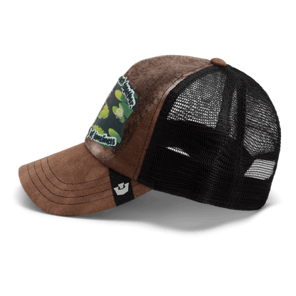 The Lil Sohei by Goorin Bros. is a brown and black mesh trucker hat from the Storybook collection, featuring a green and white front patch and a small black and white logo tag—ideal for unique hat enthusiasts.