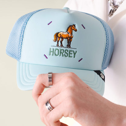 A person holds the Neo Farm - Horsey Horse cap by Goorin Bros., highlighting its stylish and breathable design.