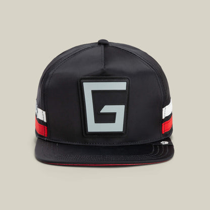 The VOID-colored “Pole Position - Road Kill” snapback hat by Goorin Bros. features a striking gray G emblem on the front and chrome satin stripes in red, white, and black on the sides, giving it a sleek racing-inspired look. This stylish cap combines bold design elements with premium detailing.