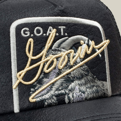 Close-up of the Goorin Bros. NeoBrand GOAT black cap with an embroidered GOAT and Goin patch over a goat’s head—ideal for pairing with your favorite monochrome sneakers for a bold, coordinated look.