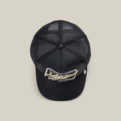 The NeoBrand GOAT by Goorin Bros. is a black mesh trucker hat with a curved brim and a partially obscured GOAT patch, photographed from above on a neutral background—ideal for pairing with monochrome sneakers.