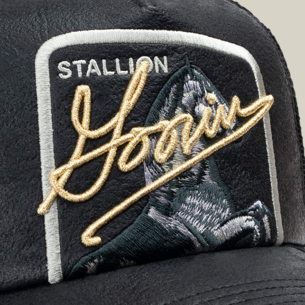 Close-up of the NeoBrand STALLION black cap by Goorin Bros., featuring monochrome embroidery with "STALLION" and "Goorin" over a horse's head.
