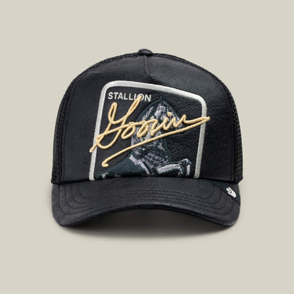 The Goorin Bros. NeoBrand STALLION is a black mesh trucker hat featuring a monochrome embroidered horse patch labeled "STALLION" and gold Goorin signature on the front.