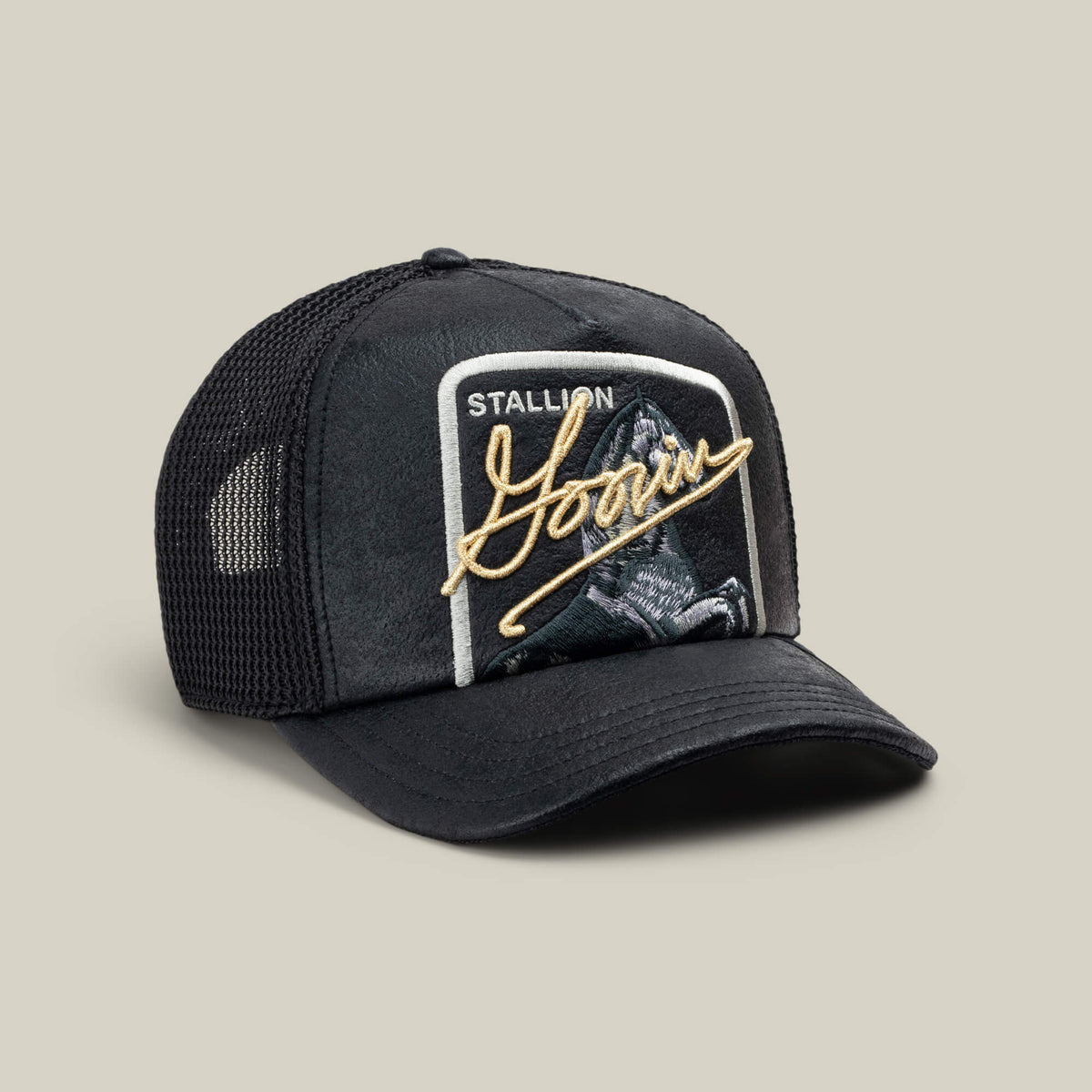 The NeoBrand STALLION by Goorin Bros. is a black mesh trucker cap featuring a front patch with monochrome horse embroidery and gold script.